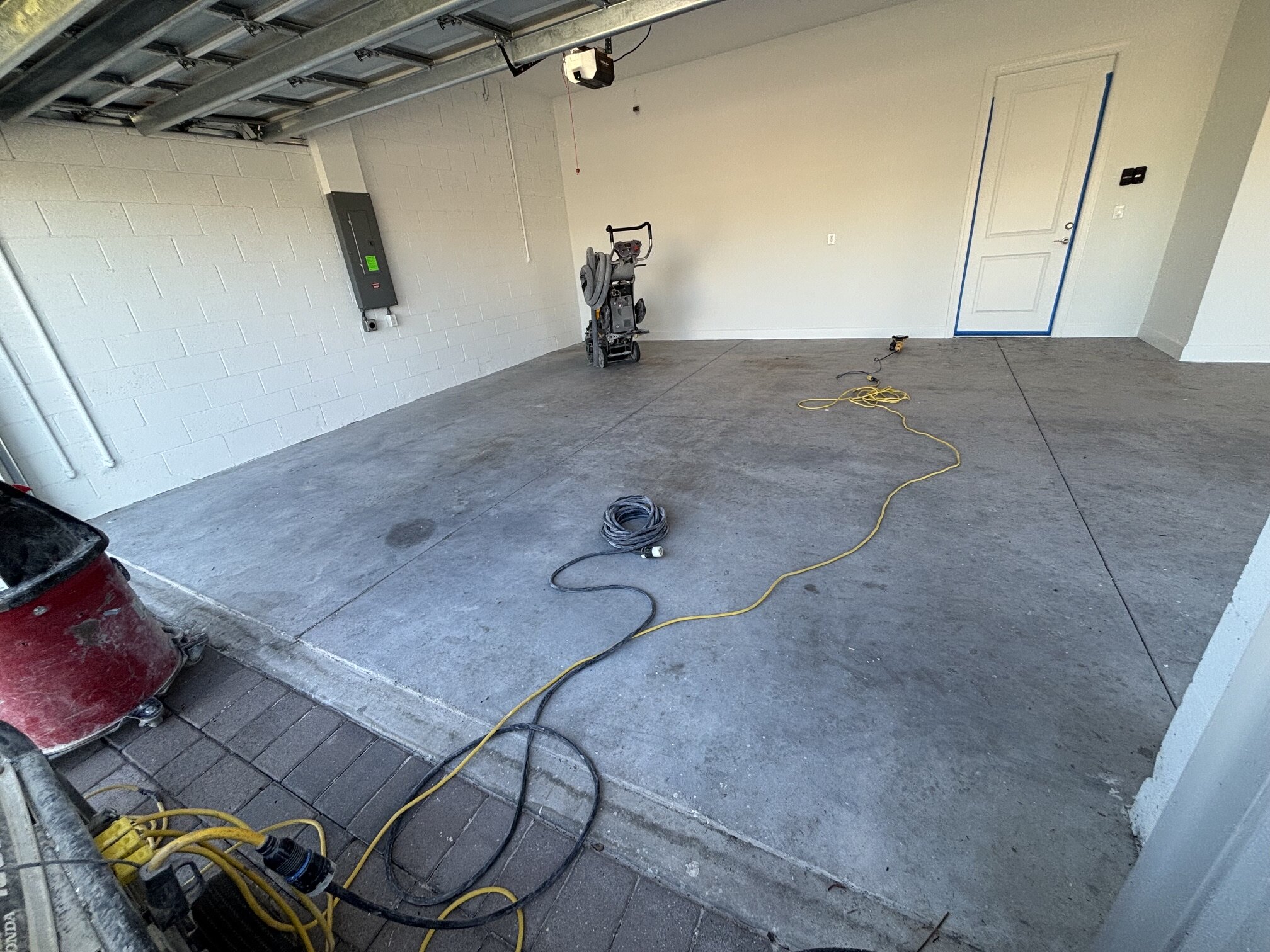 Beachwalk garage floor in Englewood during preparation, with floor equipment visible