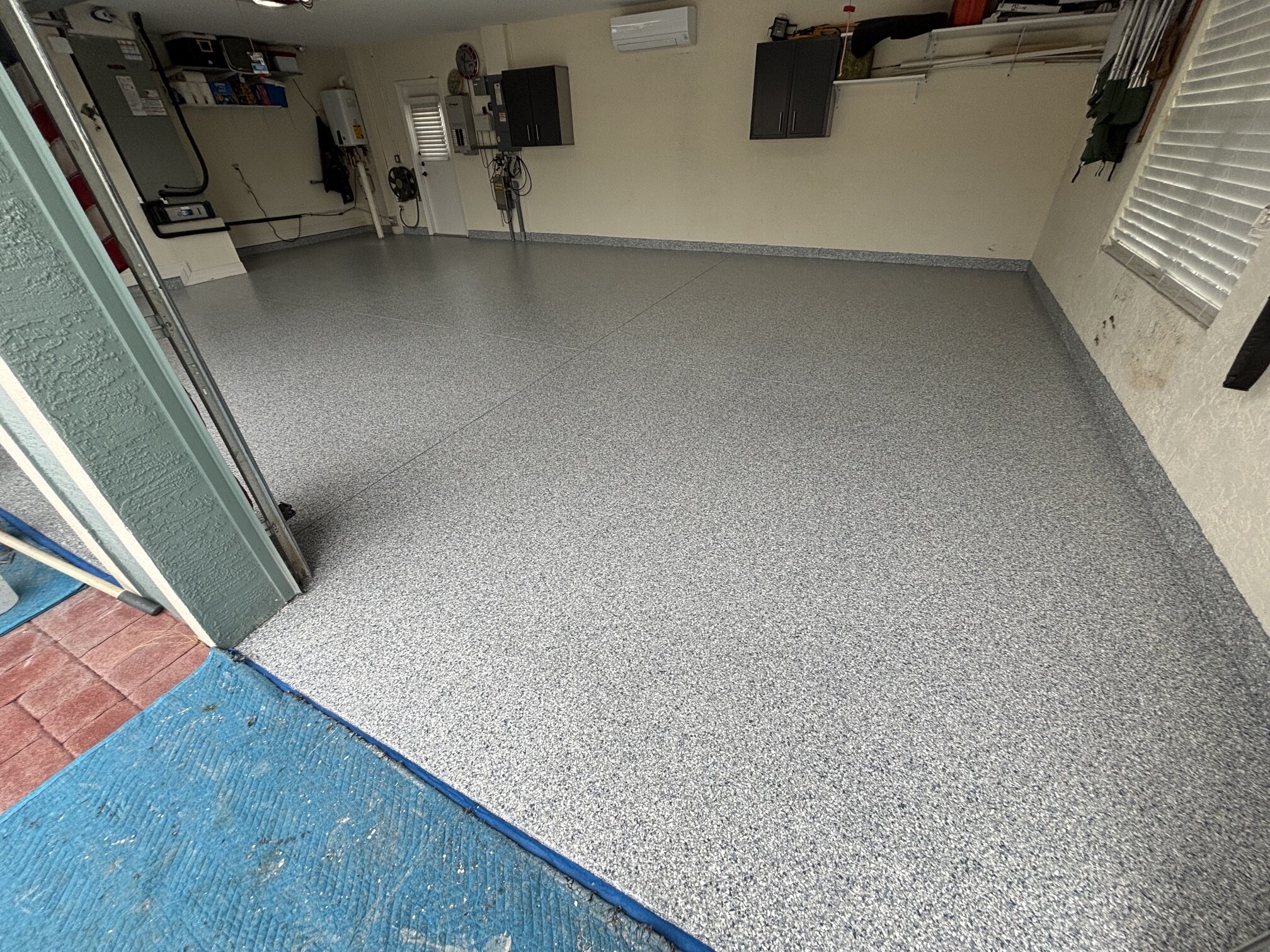 Finished Sarasota garage floor with a light gray decorative flake coating