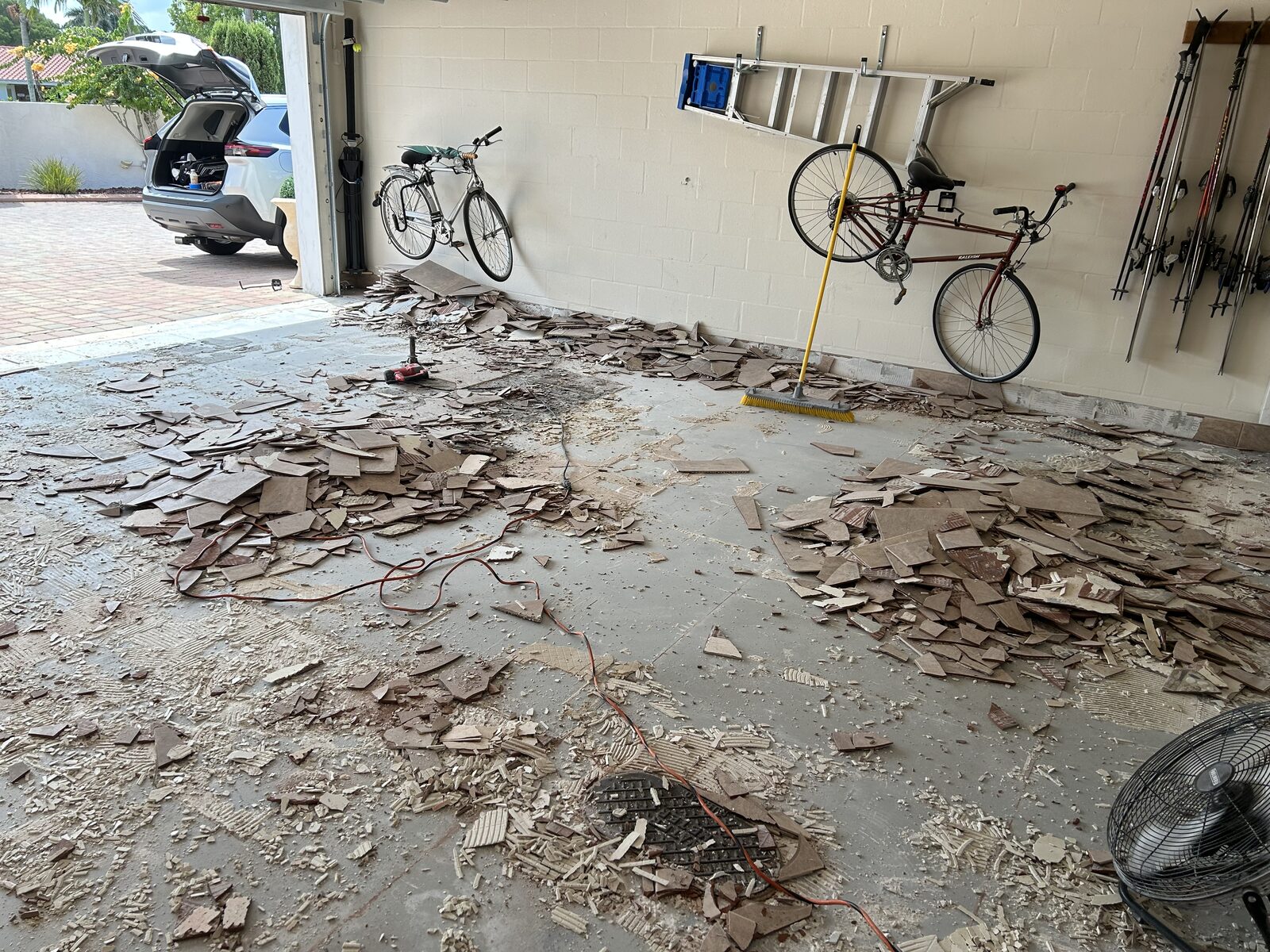 Existing garage floor material being removed during surface preparation