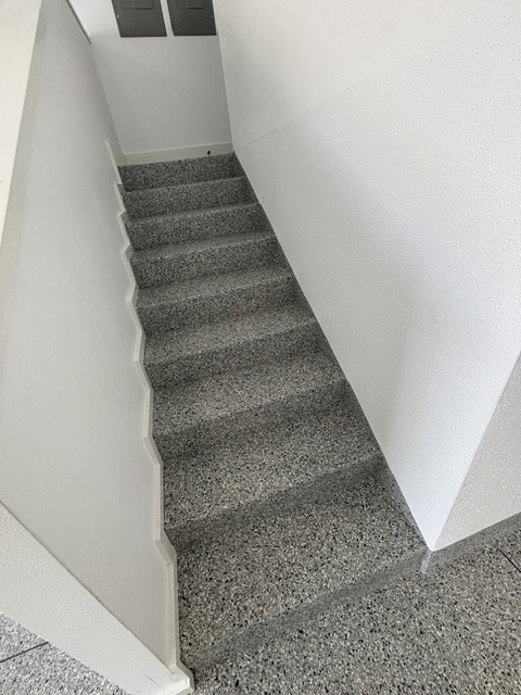 Coated interior stair landing with a decorative finish