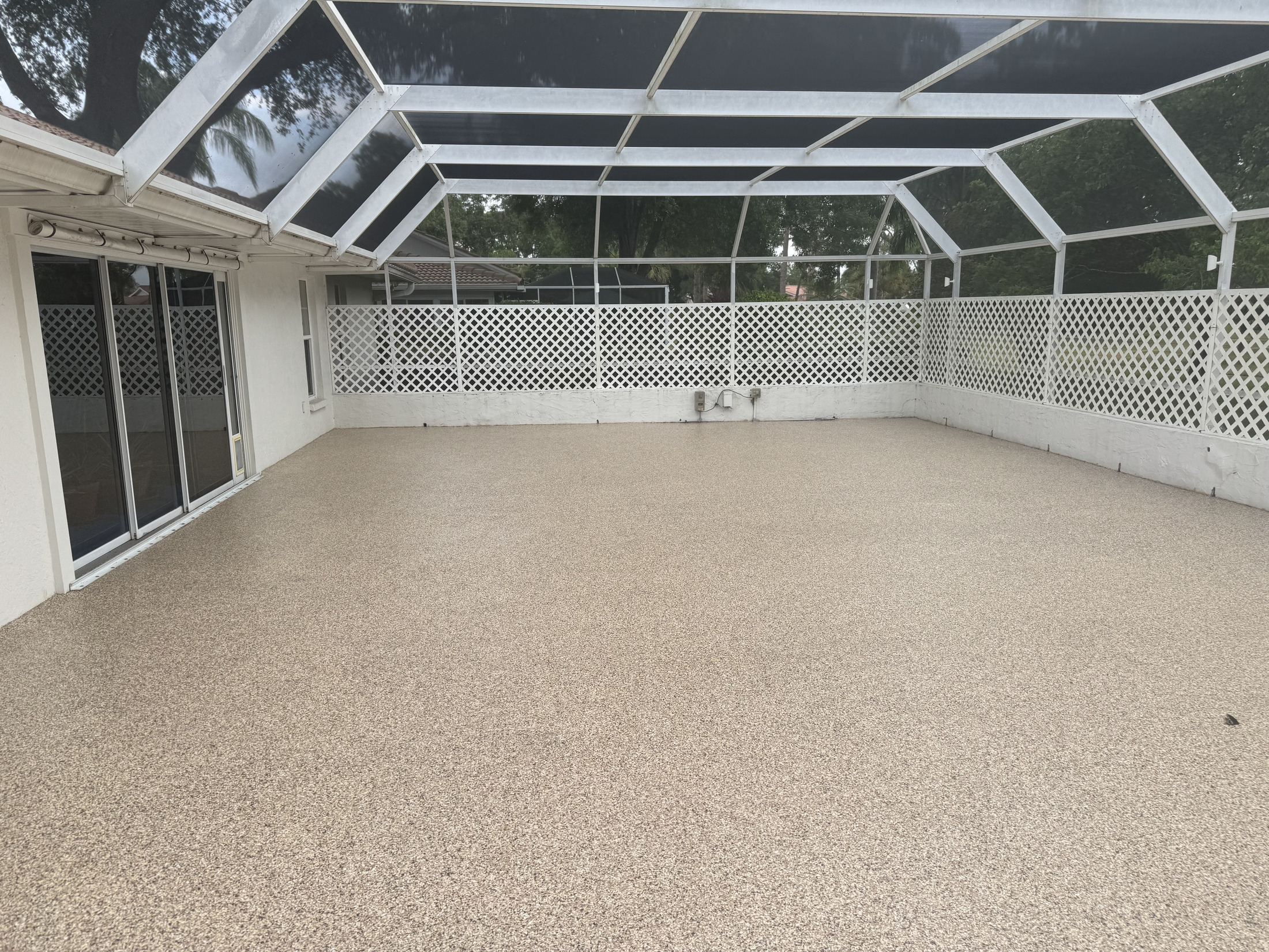 Finished decorative concrete coating across a covered patio