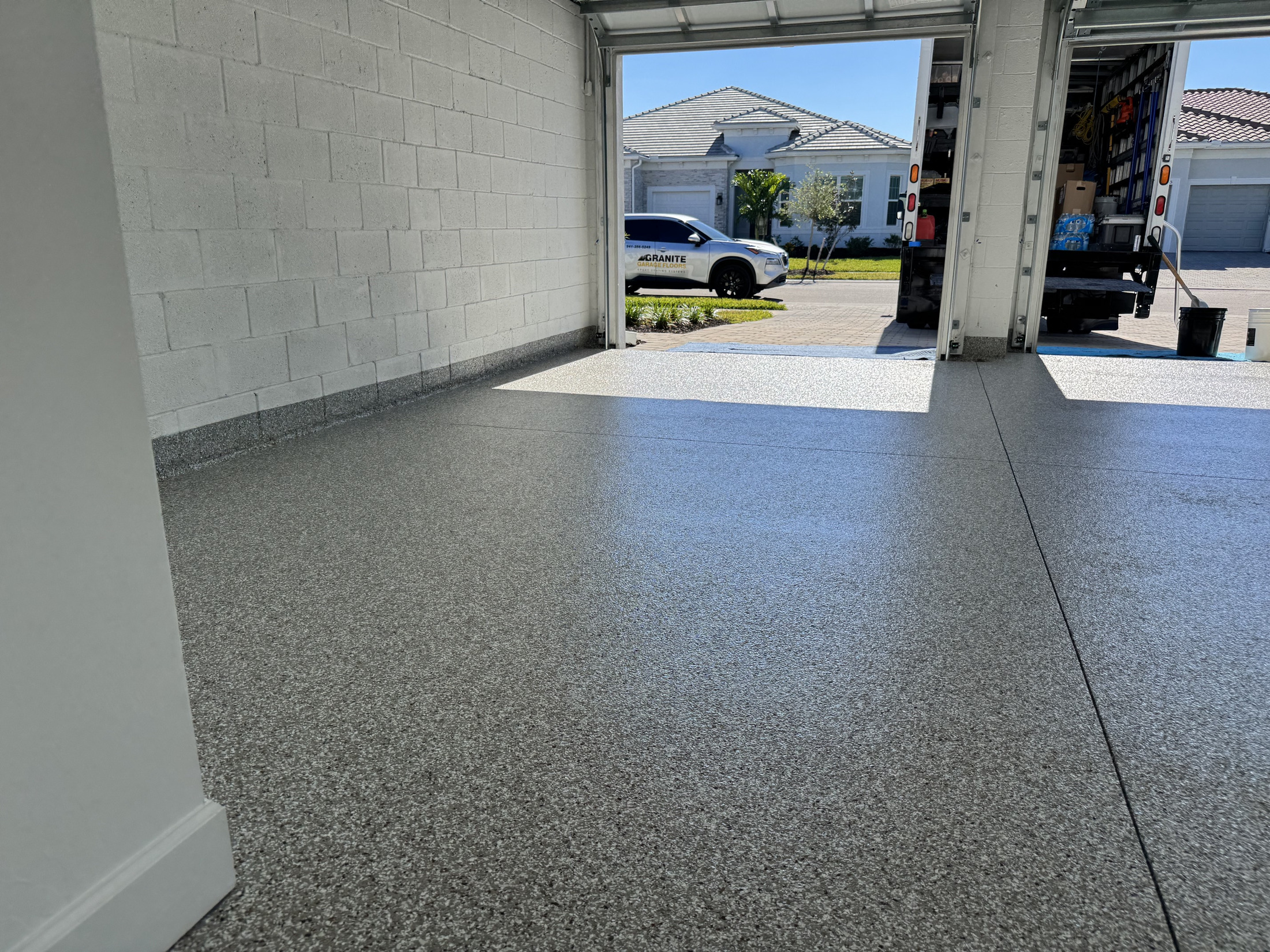 Large clean garage or workshop with a completed gray decorative floor coating