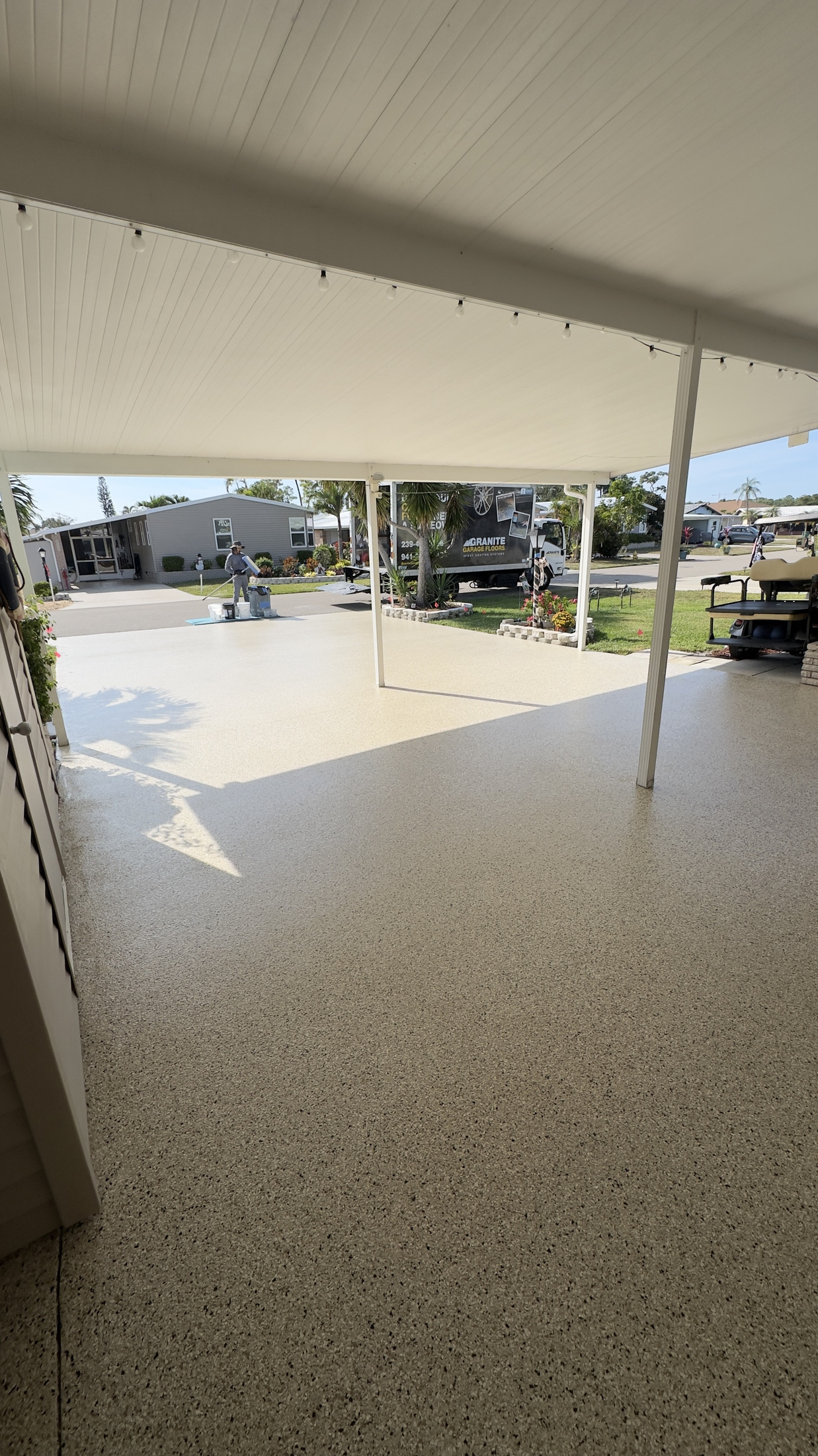 Finished decorative concrete coating across a covered Florida outdoor living area