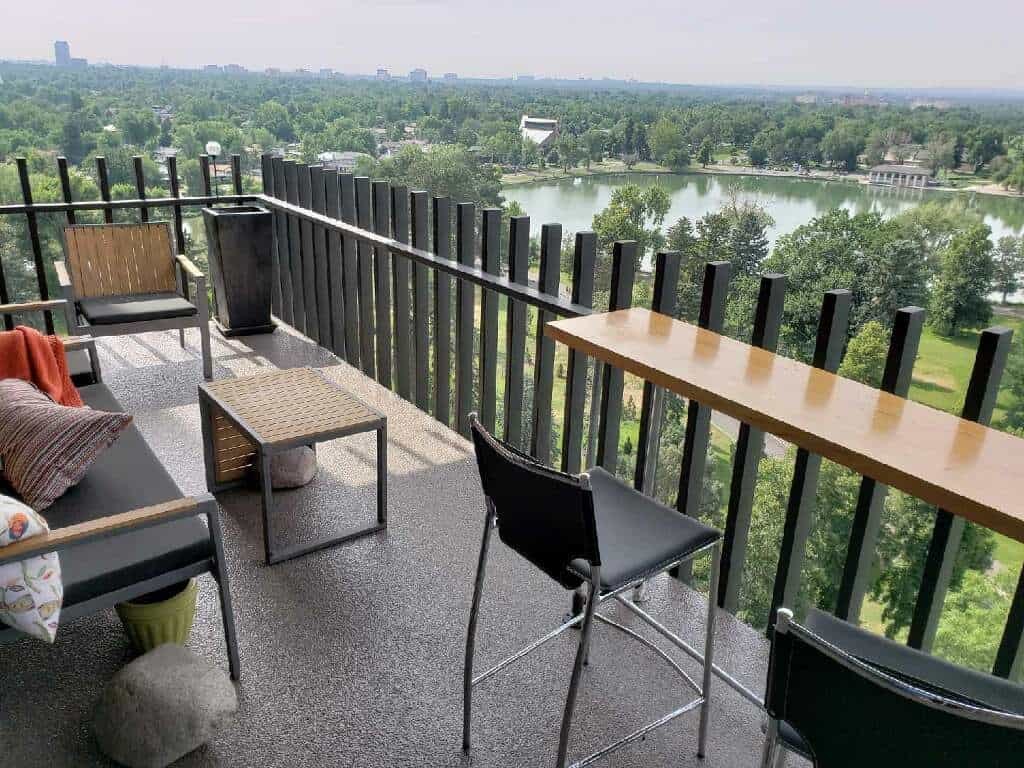 Coated balcony floor with seating and a view beyond the railing