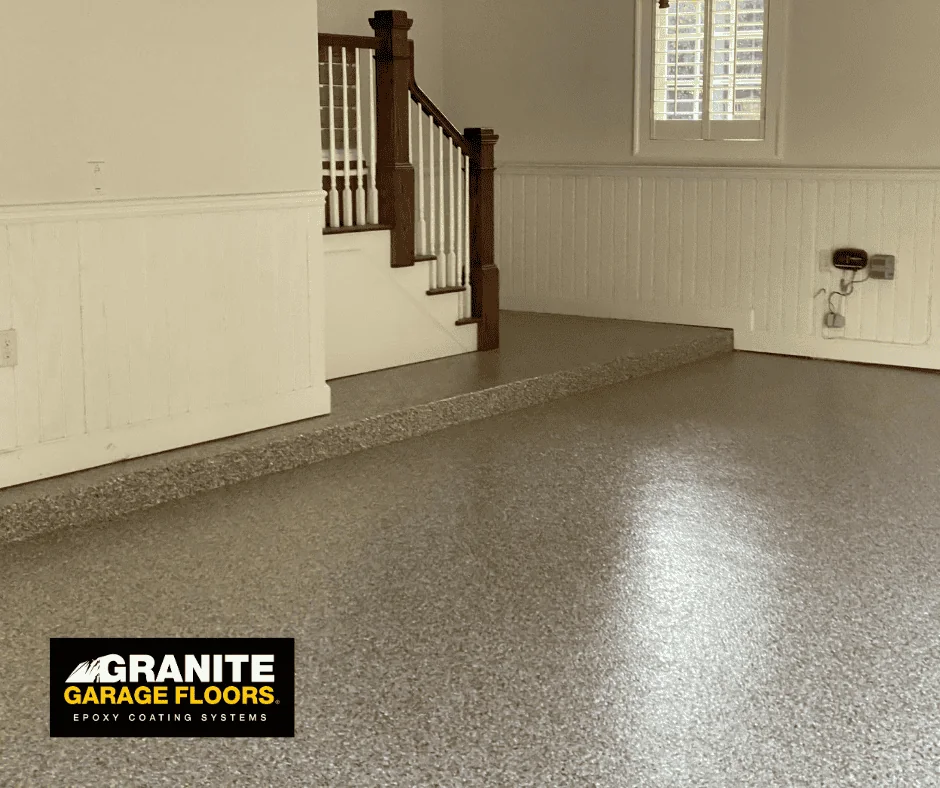 Coated entryway floor beneath an interior staircase