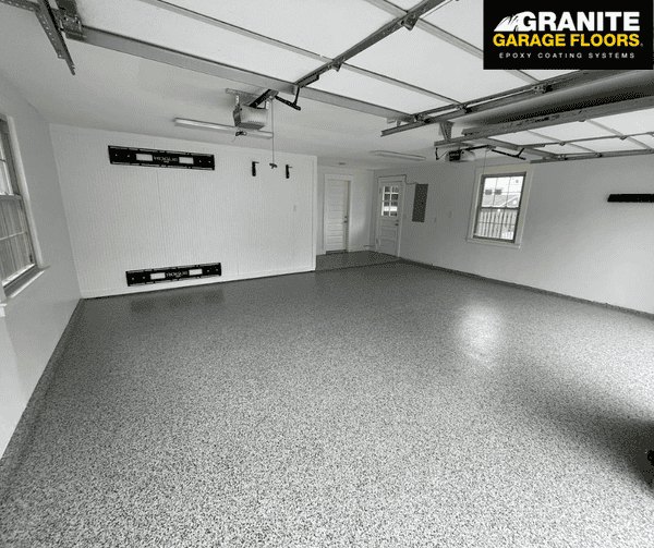 Empty residential garage with a finished decorative concrete floor